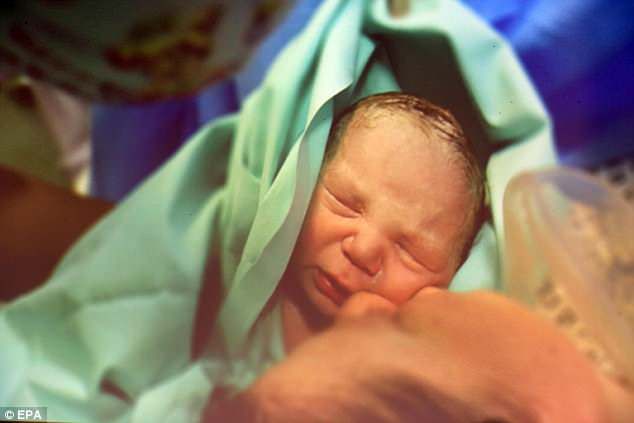 Woman, 38, gives birth to baby boy after receiving a uterus transplant from her twin sister